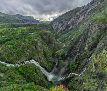 Beautiful waterfall and the river in the mountains in Norway.