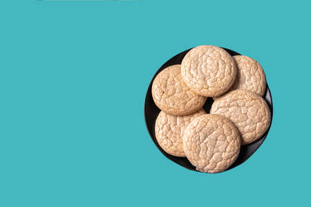 Oatmeal cookies in a black plate on a neo mint color background.の写真素材