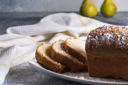 Cake Cake in a plate on a table, pears on blurred bokeh background, morning tea coffee concept.の写真素材