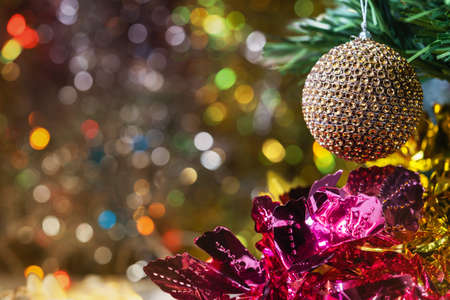 Christmas and new year decorations and illumination with a large golden ball in the foreground.の写真素材