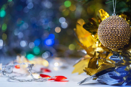Christmas and new year decorations and illumination with a large golden ball in the foreground.の写真素材