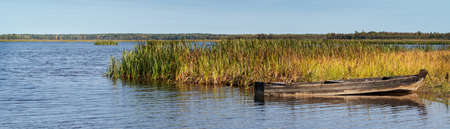Svyatoe lake in the Meshchersky region in Russia with A broken boat in the foreground.の写真素材
