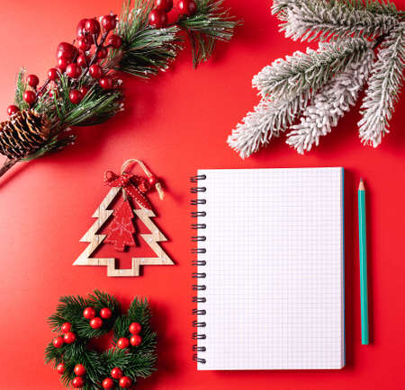 Festive Christmas and new year background with a blank Notepad sheet for writing down wishes and goals for the new year.の写真素材