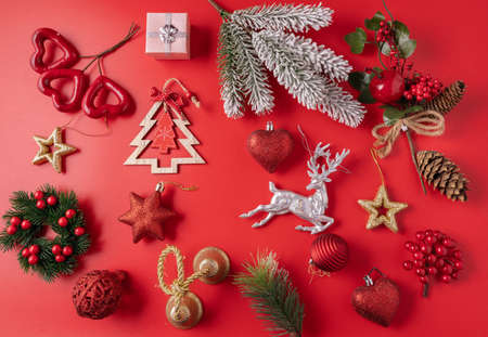 Festive Christmas and new year decorations with balls, cones and toys on red background.の写真素材