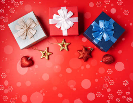 Festive Christmas and new year decoration with gift boxes and balls on red background.の写真素材