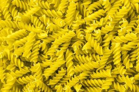 Pasta of Iluminating yellow color background - the fashionable color of 2021, flat lay.の写真素材