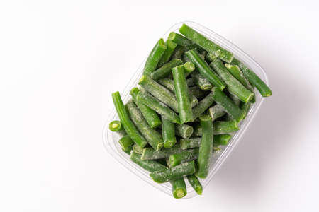 Frozen green beans in plastic box isolated on white background, flat lay.の写真素材