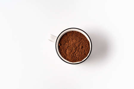Black coffee powder in a white cup top view isolated on white background, copy space for text.の写真素材