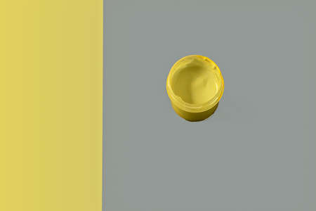 Illuminating and an ultimate gray colors paper background - the most fashionable colors of 2021, and an yellow mug on it, flat lay.の写真素材
