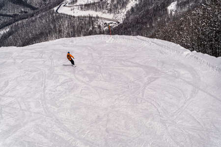 March 22, 2021, Alpika ski resort, Sochi, Russia: Extreme Snowboarding in the mountain ski resort of Krasnaya Polyana, Sochi, Russia.のeditorial素材