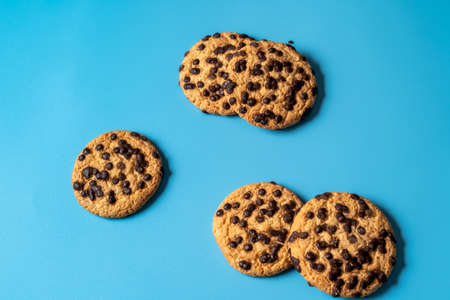 Chocolate cookies background over blue background, flat lay.の写真素材