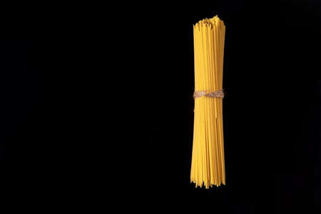 Pasta, spaghetti on a black background top view with copy space.の写真素材