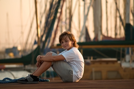 Portrait of a boy on the docks at the yacht club in Tel Aviv.の写真素材