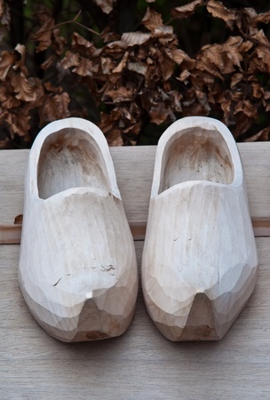 Pair of traditional Dutch  wooden shoes on a wooden table .の写真素材