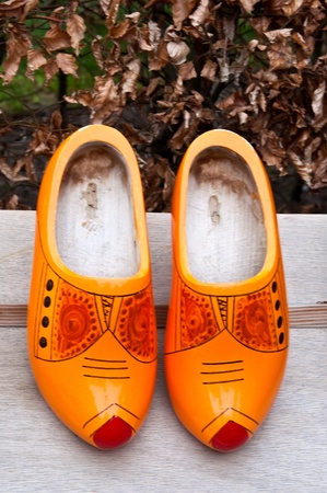 Pair of traditional Dutch  wooden shoes on a wooden table .の写真素材