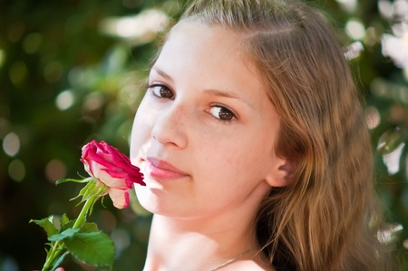 Portrait of a young girl with a rose.の写真素材