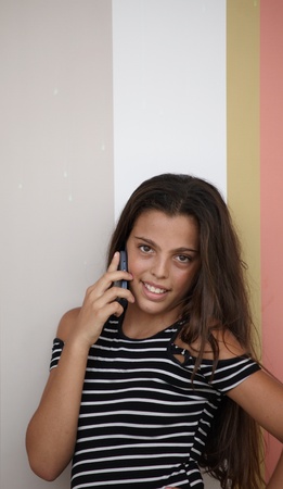Beautiful teenage girl callng on her cell phone .の写真素材