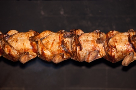 Chickens on grill on background of flames.の写真素材