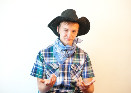 Portrait of a teenager boy in a blue plaid shirt and cowboy hat の写真素材