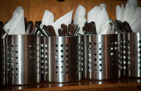 Cutlery and napkins prepared for serving tables in the restaurant.の写真素材