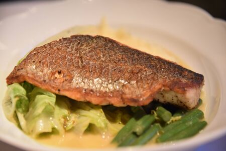 Baked fillet of sea bass with vegetables and mashed potato .