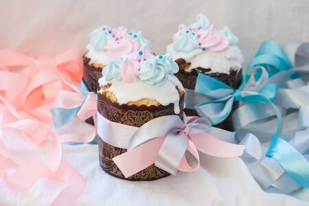 Russian easter bread kulich decorated in soft pastel pink and blue colors. White background.