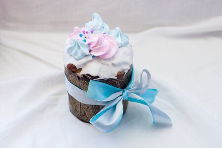 Traditional orthodox easter cake kulich with festive blue, purple and pink decoration. White...