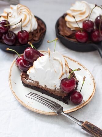 Mini tarts with oreo cookie dough, chocolate filling, whipped cream and fresh berries.の写真素材