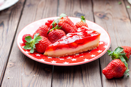 Piece of strawberry cheese cake with fresh strawberry for birthday on rustic wooden backgroundの写真素材