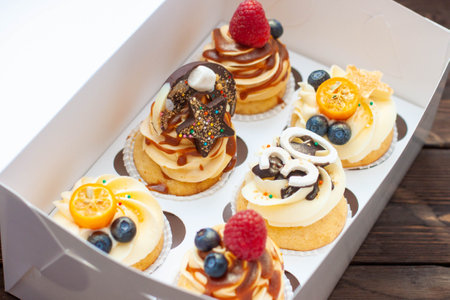 Festive cupcakes in cardboard box with berries for a 30th birthday anniversaryの写真素材