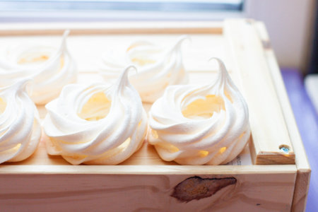 Close up of whipped baked meringues on wooden boxの写真素材