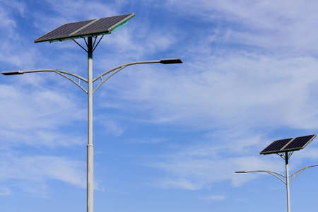 solar panel on lamppost against blue skyの写真素材