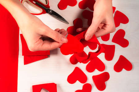 Cut out hearts from paper stencil. DIY step by step decor Valentine for Valentine's Day. Paper homemade valentines. view from above. flat lay. Instructions for making valentine with your own hands. stの写真素材
