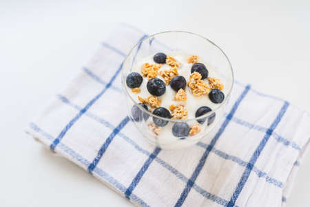 yogurt with cereal and blueberries. Healthy low calorie breakfast. Healthy blueberries with natural yogurt and oatmeal flakesの写真素材