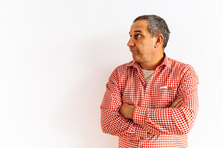Portrait of a middle-aged man in a red shirt on a white backgroundの写真素材