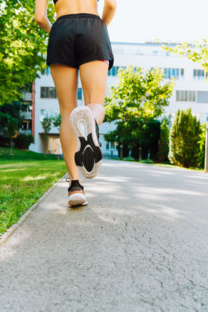 Young woman running in the city. Fitness and healthy lifestyle concept.