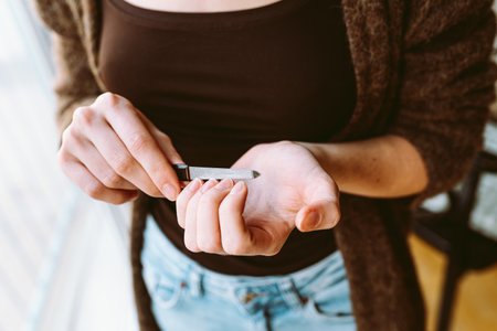 Close up of young woman with manicure holding nail file in her handsの写真素材