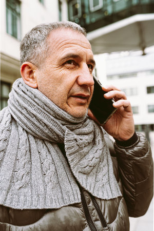 Portrait of a senior man talking on the phone in the cityの写真素材
