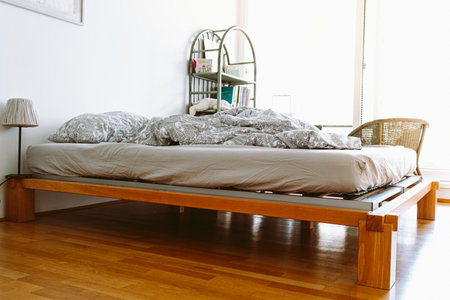 interior of a bedroom with a bed and pillows, nobody. unmade duvets bedroomの写真素材