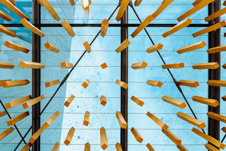 Abstract background of falling wooden dominoes on the glass ceiling.の写真素材