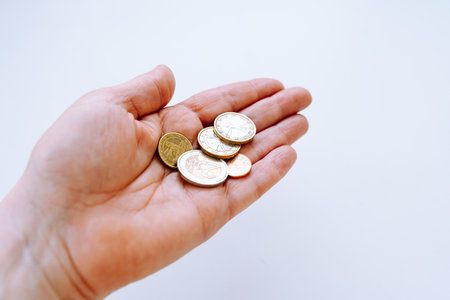 Coins in hand on white background. business and finance concept.の写真素材