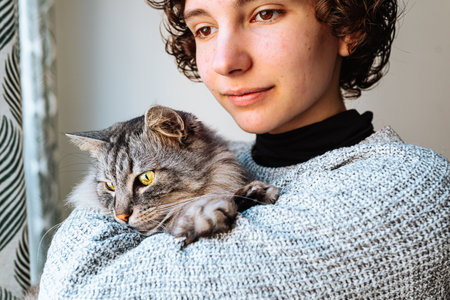 Portrait beautiful young woman with cat in armsの写真素材