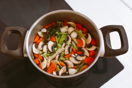 Vegetable soup with mushrooms, carrots and onions in a potの写真素材