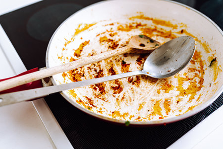 Dirty frying pan, with ceramic coating, with remnants burnt foodの写真素材