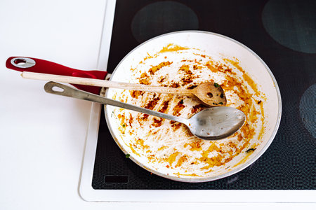 Dirty frying pan, with ceramic coating, with remnants burnt foodの写真素材