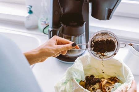 Throwing Away Used Coffee Groundの写真素材