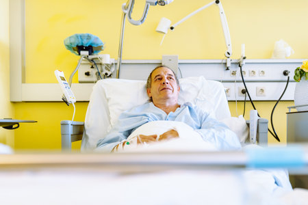 Male patient after injury or surgery in hospital wardの写真素材