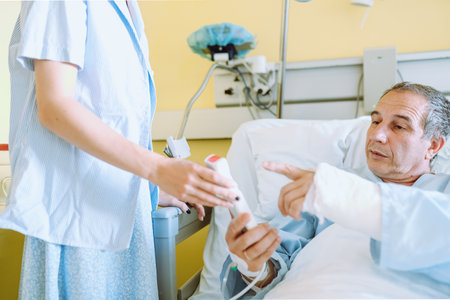 Male patient after injury or surgery in hospital wardの写真素材