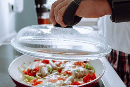 Man with adjustable elbow brace preparing foodの写真素材