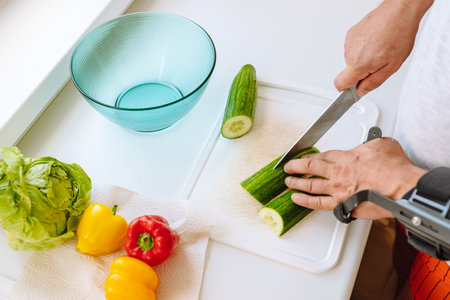 Man with injured hand making salad